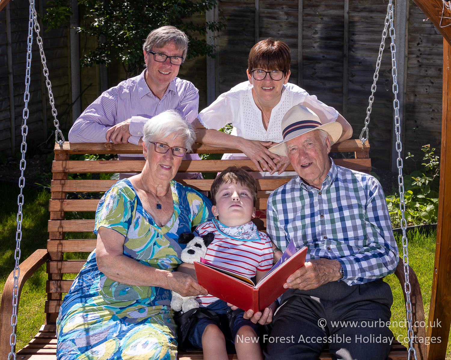 Sam enjoying story time in the garden with his grandparents